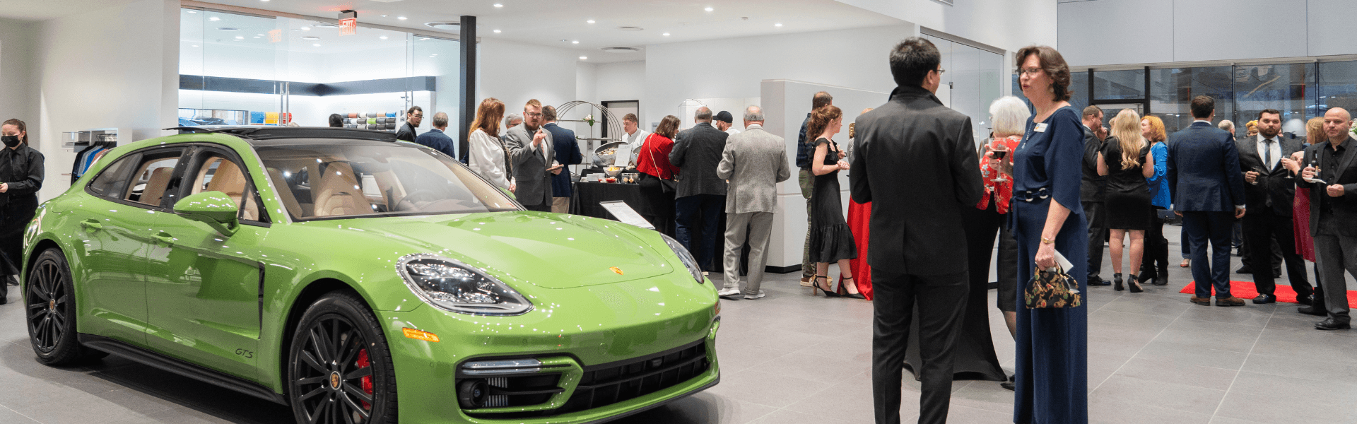 People gathered around the Porsche Charlottesville showroom for the dealership grand opening